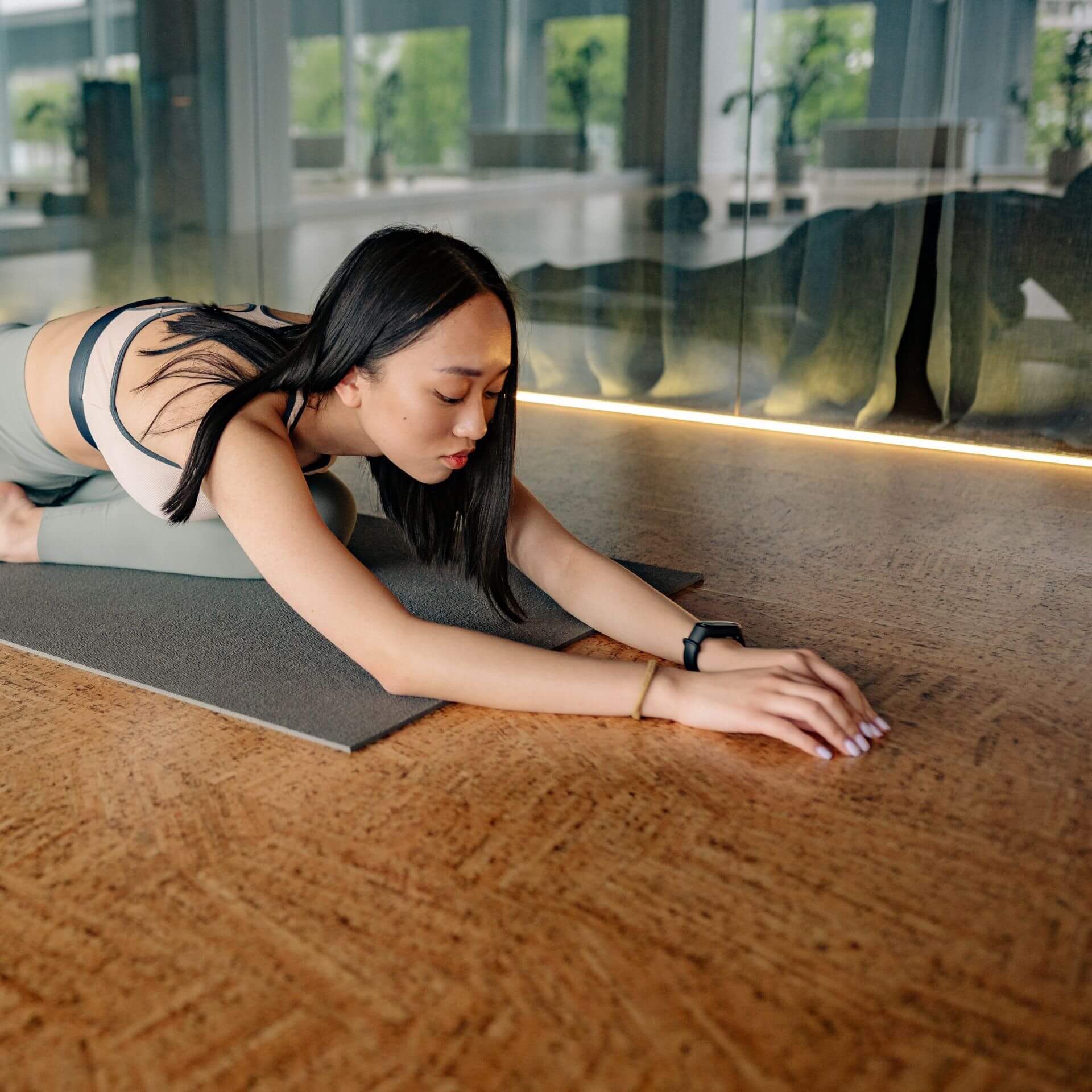 Woman stretching on yoga mat